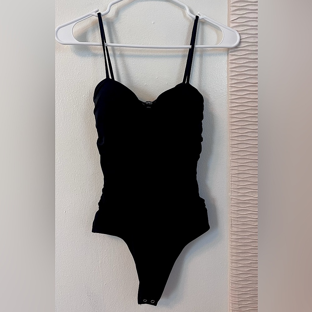 Express body contour. Size small. Fitted bodysuit. Black, thong bottom.